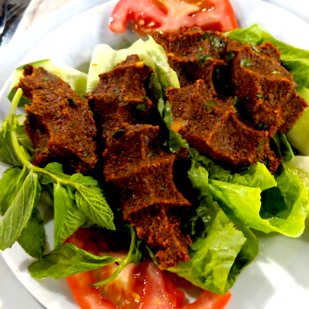 Raw turkish traditional dish meat kebab with herbs and spices